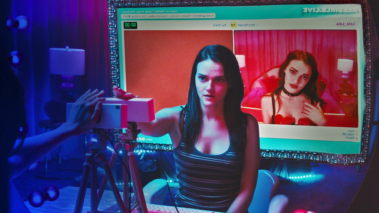 Her online followers are stolen by a doppelganger who not only takes over her channel but also pushes the boundaries of eroticism to the extreme. Is this a case of identity theft, or is there a supernatural force at play determined to ruin her life?